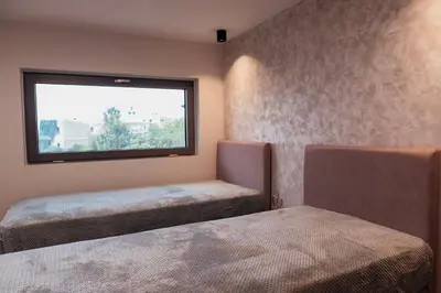 a room with two beds and a window at MP Apartments in Chania Town