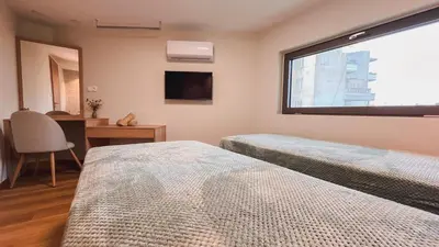 a bedroom with two beds and a window at MP Apartments in Chania Town
