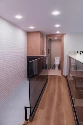 a bathroom with a toilet and a glass wall at MP Apartments in Chania Town
