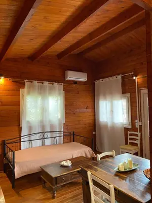 a bedroom with a bed and a table in a room at La Irilia Residences & Retreat in Agios Padeleimon