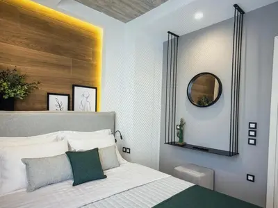 a bedroom with a bed with a mirror on the wall at Amazing views in Chania Town