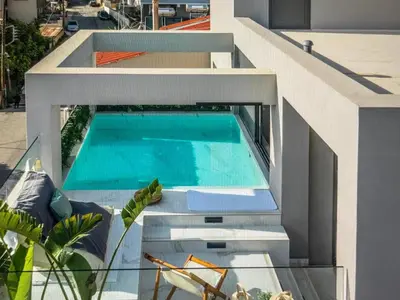 a swimming pool on the side of a house at Amazing views in Chania Town