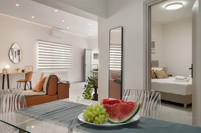a plate of fruit on a glass table in a living room at Coralie 3 bedroom apartment 40m from the beach in Chania Town