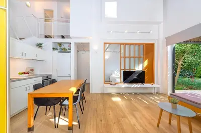 a kitchen and living room with a table and chairs at Central cozy garden flat in Chania Town