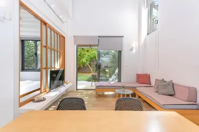 a living room with a couch and a table at Central cozy garden flat in Chania Town