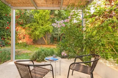 two chairs and a table on a patio at Central cozy garden flat in Chania Town