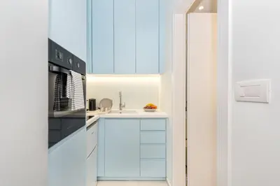 a kitchen with blue cabinets and a sink at Αthena Studio 3 in Chania Town