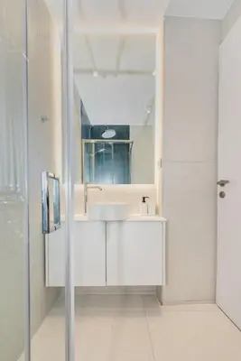 a white bathroom with a sink and a mirror at Αthena Studio 3 in Chania Town