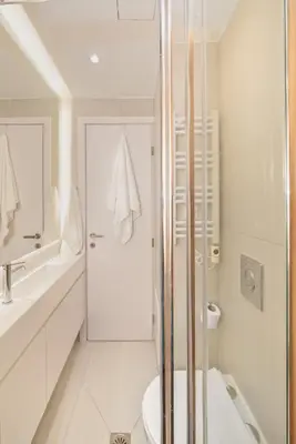 a white bathroom with a shower and a toilet at Athena Studio 1 in Chania Town