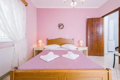 a bedroom with a bed with two towels on it at Creta Sea View 2BR Maisonette by ΜΡS in Marathokefála