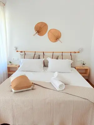 a bedroom with a bed with two towels on it at Athina's Cozy Guest House in Kamisianá