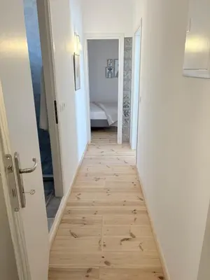 a hallway with a wooden floor in a room at Athina's Cozy Guest House in Kamisianá