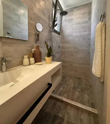 a bathroom with a sink and a mirror at Athina's Cozy Guest House in Kamisianá