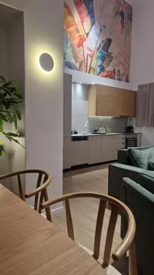 a kitchen and dining room with a table and chairs at Hanim 2BR Loft Apartment - Garden & Indoor Parking in Chania Town
