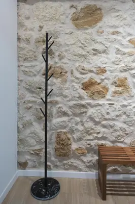 a plant in a room with a stone wall at Hanim 2BR Loft Apartment - Garden & Indoor Parking in Chania Town
