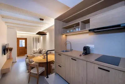a kitchen with a sink and a table in a room at Bōw Ground Floor Luxury Apt-In Chania Old Town! in Chania Town
