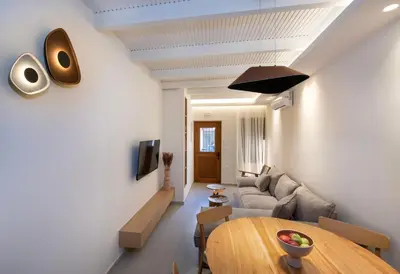 a living room with a table and a couch at Bōw Ground Floor Luxury Apt-In Chania Old Town! in Chania Town