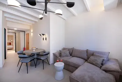 a living room with a couch and a table at BŌW 1st Floor Luxury Apt -Heart of Chania Old Town in Chania Town