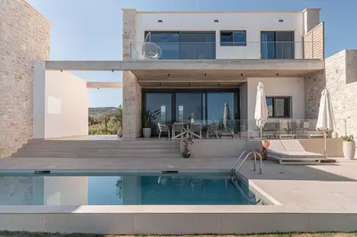a house with a swimming pool in front of it at Himmel Villas - Seaview luxury & private pools in Kalivianí