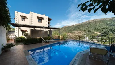 a villa with a swimming pool and a mountain at Villa Eleni Meskla in Mesklá