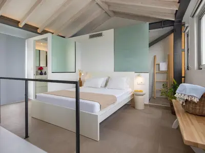 a bedroom with a large bed in a room at Omorphi Seaside Villa in Kalyves