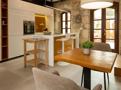 a kitchen and dining room with a table and chairs at Omorphi Seaside Villa in Kalyves