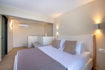 a bedroom with a large white bed with two pillows at BŌW 2nd Floor Luxury Apt -Heart of Chania Old Town in Chania Town