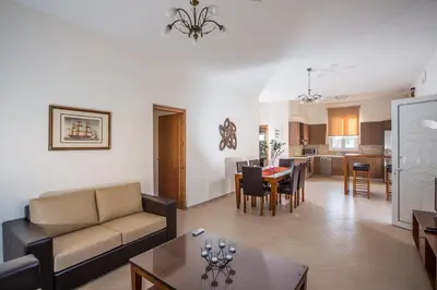 a living room with a couch and a table at Lila Villas in Stalos