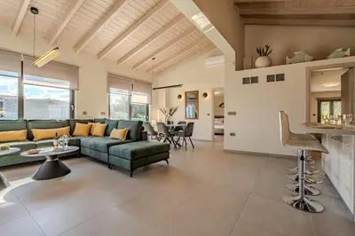 a living room with a couch and a table at Seawhisper Villa in Kalyves