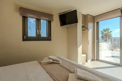 a bedroom with a bed with a flat screen tv at Seawhisper Villa in Kalyves