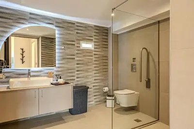 a bathroom with a sink and a toilet and a mirror at Seawhisper Villa in Kalyves