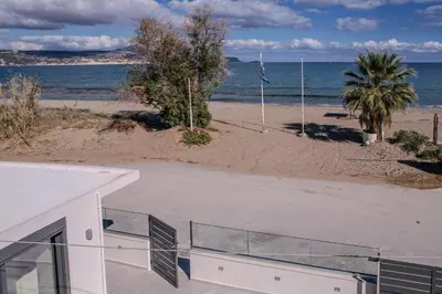 a view of the beach from the balcony of a house at Seawhisper Villa in Kalyves