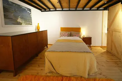 a bedroom with a large bed and a dresser at Agapi in Kissamos
