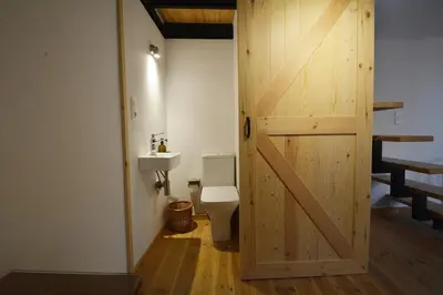 a bathroom with a toilet and a wooden door at Agapi in Kissamos