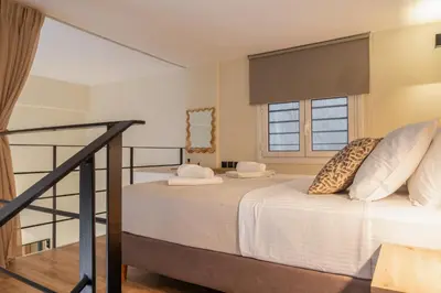 a bedroom with two beds and a staircase at La Petite Fleur City apartment Chania in Chania Town