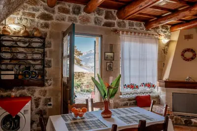a dining room with a table and a window at Maria's Serene Countryside Retreat in Chania Town