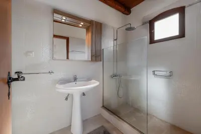 a bathroom with a sink and a glass shower at Vamos villa in Vamos