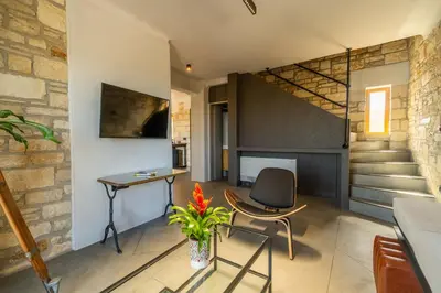 a room with a chair and a desk and a table at Villa Seiri by PosarelliVillas in Gavalochori