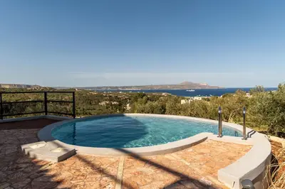 a swimming pool with a view of the ocean at Villa Seiri by PosarelliVillas in Gavalochori