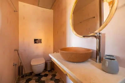 a bathroom with a bowl sink and a mirror at Villa Lavidona by PosarelliVillas in Gavalochori