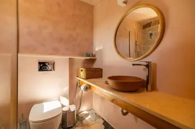 a bathroom with a wooden bowl sink and a mirror at Villa Lavidona by PosarelliVillas in Gavalochori