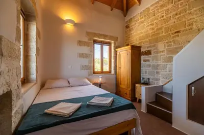 a bedroom with a bed with towels on it at Villa Lavidona by PosarelliVillas in Gavalochori
