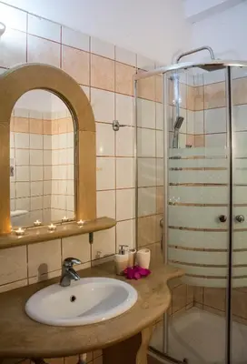 a bathroom with a sink and a shower at Villa Dimitris in Kalamitsi Amygdali