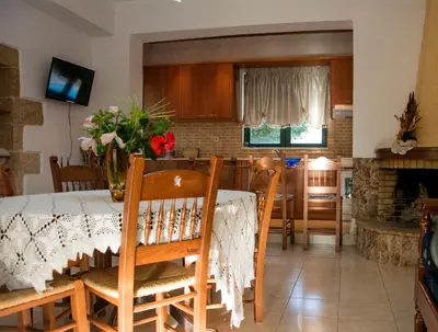 a dining room and kitchen with a table and chairs at Villa Dimitris in Kalamitsi Amygdali