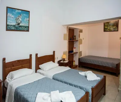 a hotel room with two beds in a room at Villa Dimitris in Kalamitsi Amygdali