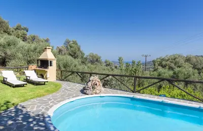 a swimming pool in a yard with a gazebo at Villa Olive Xrisi in Kafoúros