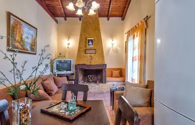 a living room with a couch and a fireplace at Villa Olive Xrisi in Kafoúros