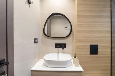 a bathroom with a white sink and a mirror at Chania Experience Residence in Chania Town