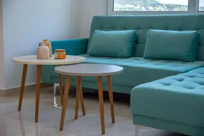 a couch and two tables in a living room at Huzuri Retreat in Kissamos