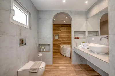 a bathroom with a toilet and a sink and a tub at Huzuri Retreat in Kissamos